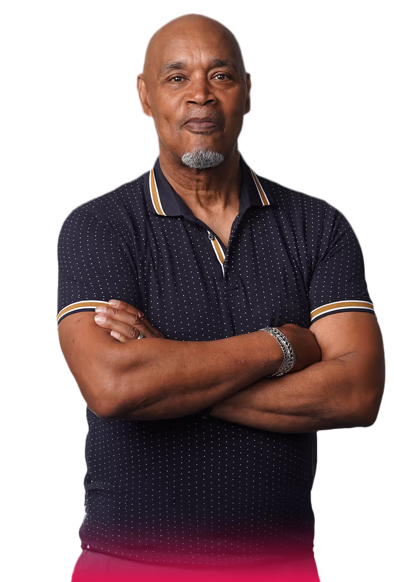 middle aged man wearing a navy blue polo with his arms crossed